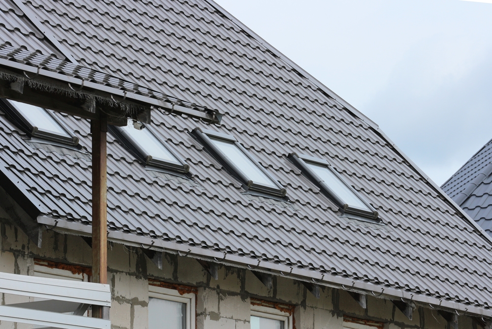 Standing seam metal roofing system featuring integrated skylights for improved natural light, weather resistance, and modern curb appeal - Metal Roofing in San Diego.