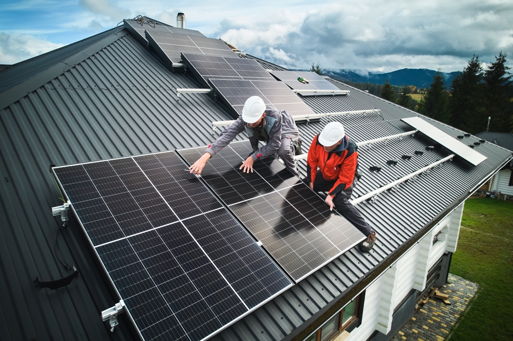 Skilled technicians installing solar panels on a metal roof with precision, demonstrating expert workmanship from trusted solar installers in San Marcos.
