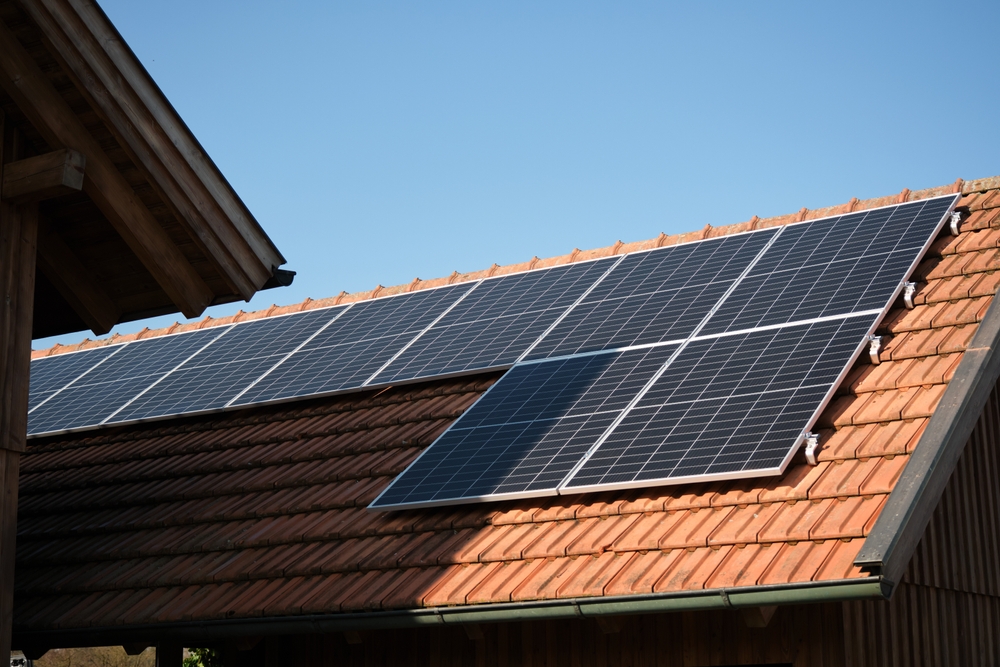 Residential solar panels securely mounted on a clay tile roof, showcasing careful installation and roof protection by experienced solar installers in San Marcos.