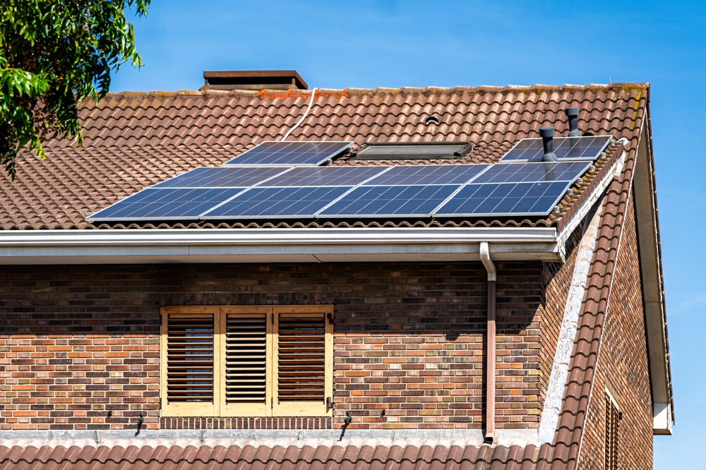 A residential brick home featuring a secure and well-aligned solar panel system designed and installed by trusted solar installers in Escondido.