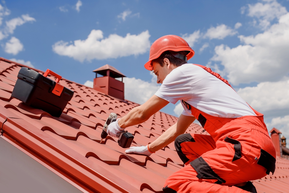 Professional roofer installing durable roof tiles with precision and safety, ensuring long-lasting protection and a clean finished look - Roof Tiles San Diego.
